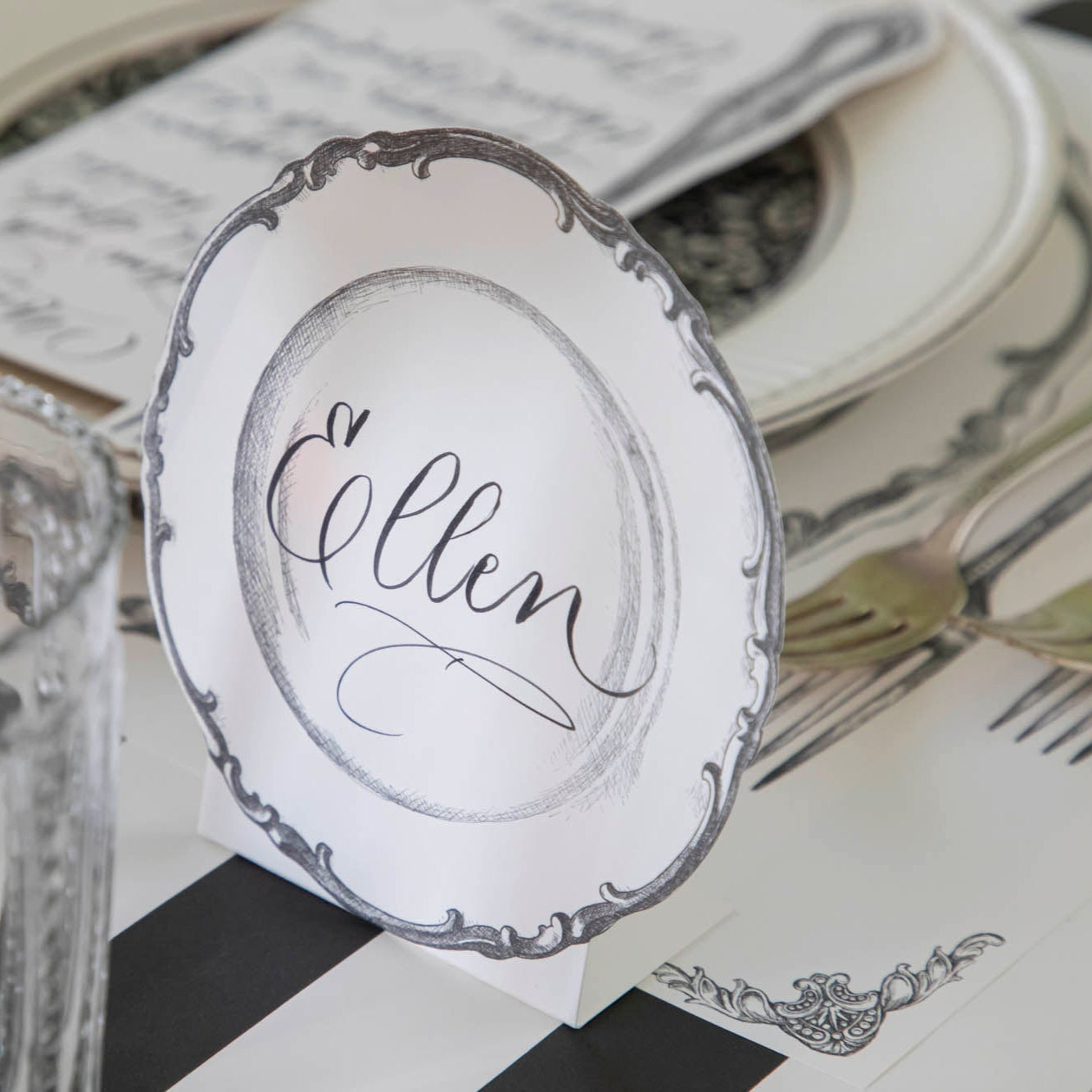 Vintage Plate Place Card with "Ellen" written on it, behind a place setting for one.