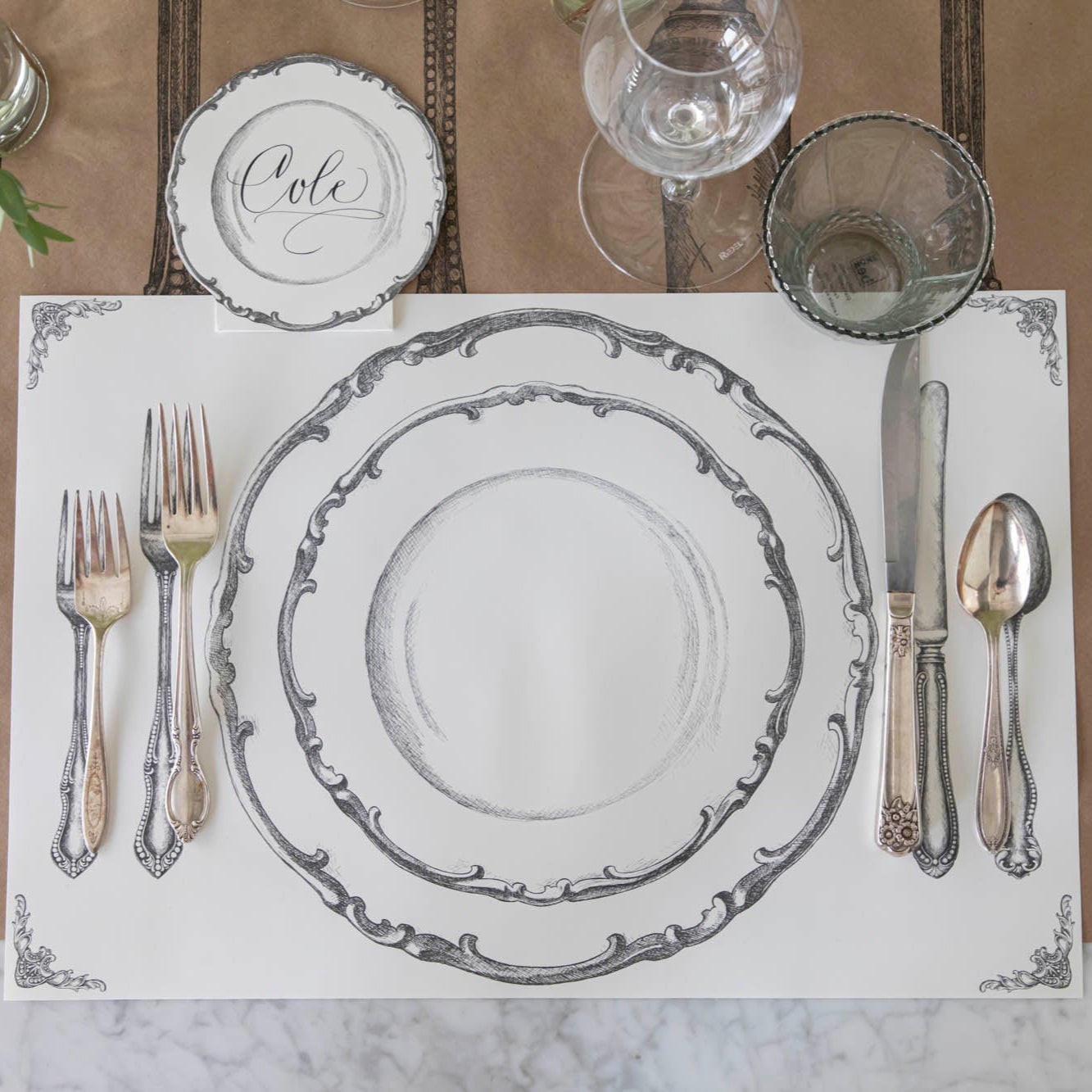 Vintage Plate Place Card with "Cole" written on it, laying flat behind the Perfect Place Setting Placemat.