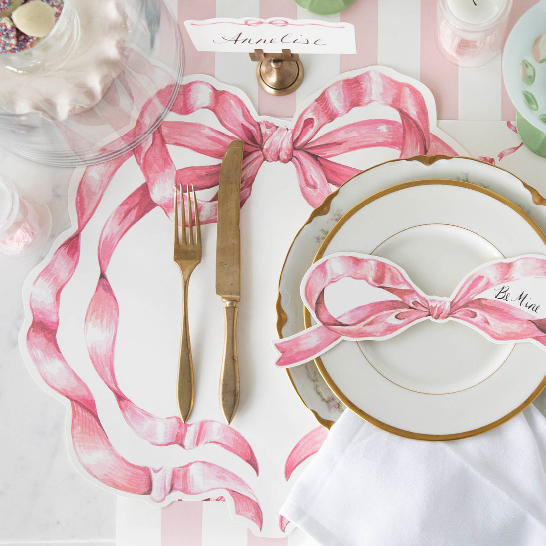 A Die-cut Pink Bow Placemat under a soft place setting, from above.