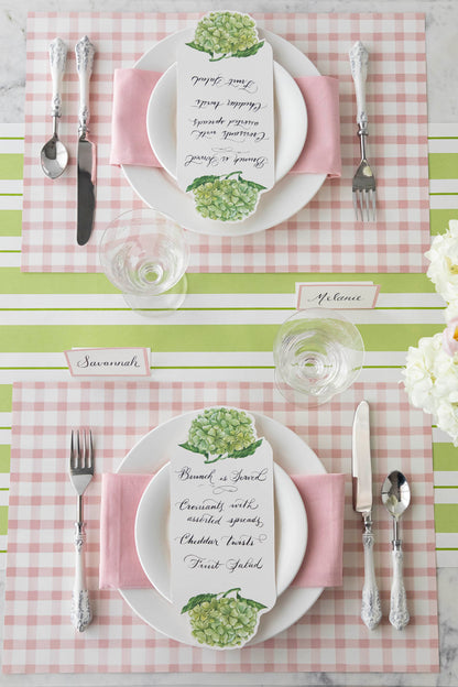 The Pink Painted Check Placemat under an elegant table setting for two, from above.