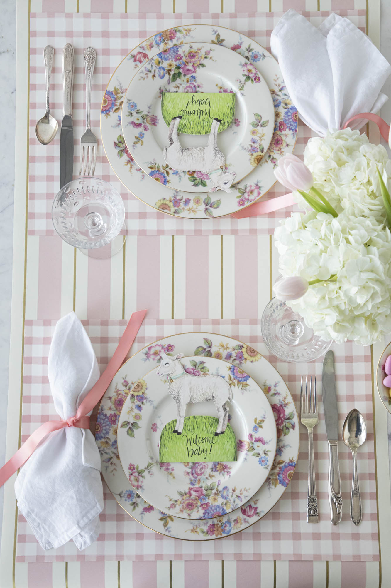 The Pink Painted Check Placemat under an elegant Easter-themed table setting, from above.
