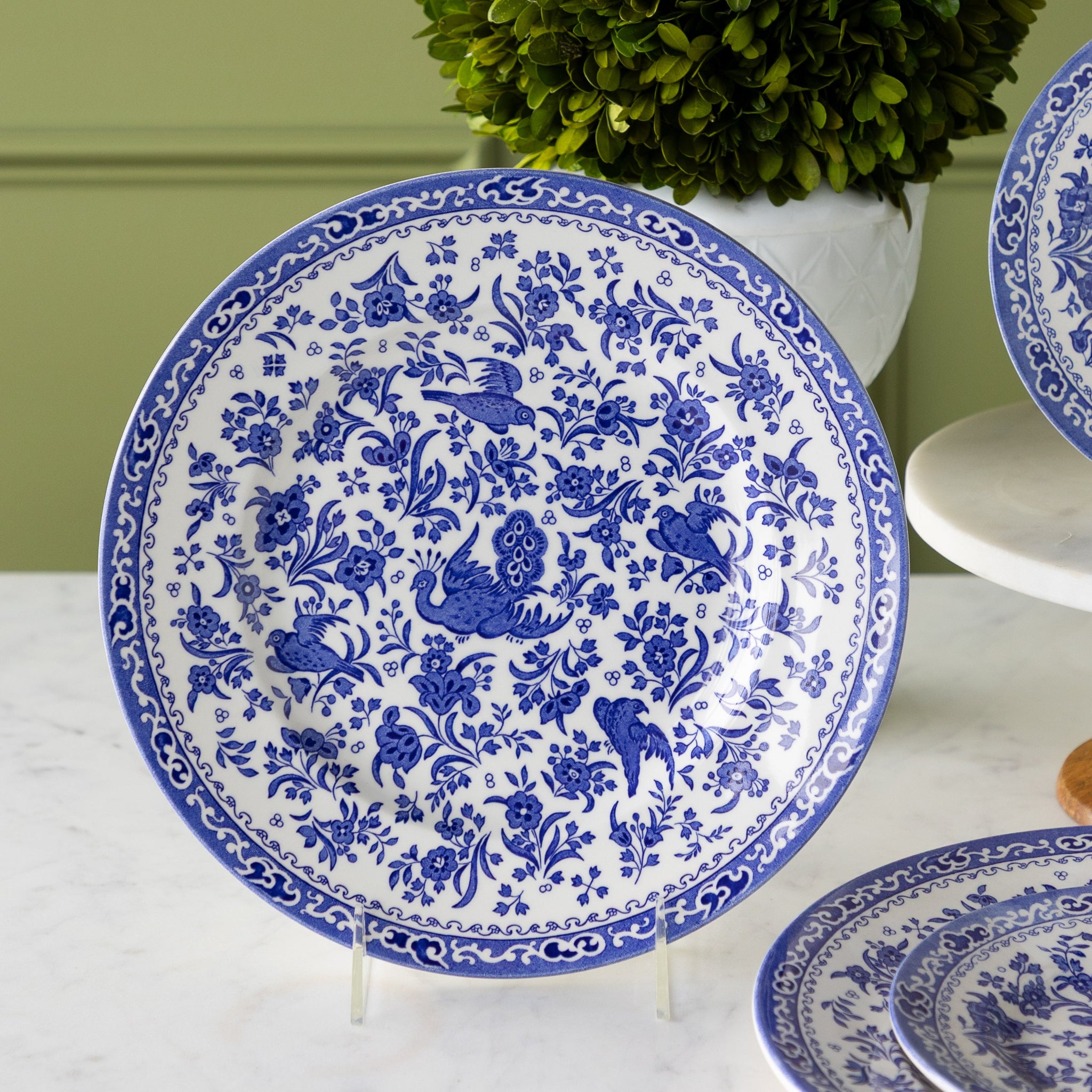 Burleigh Blue Regal Peacock Dinner Plate on a stand.