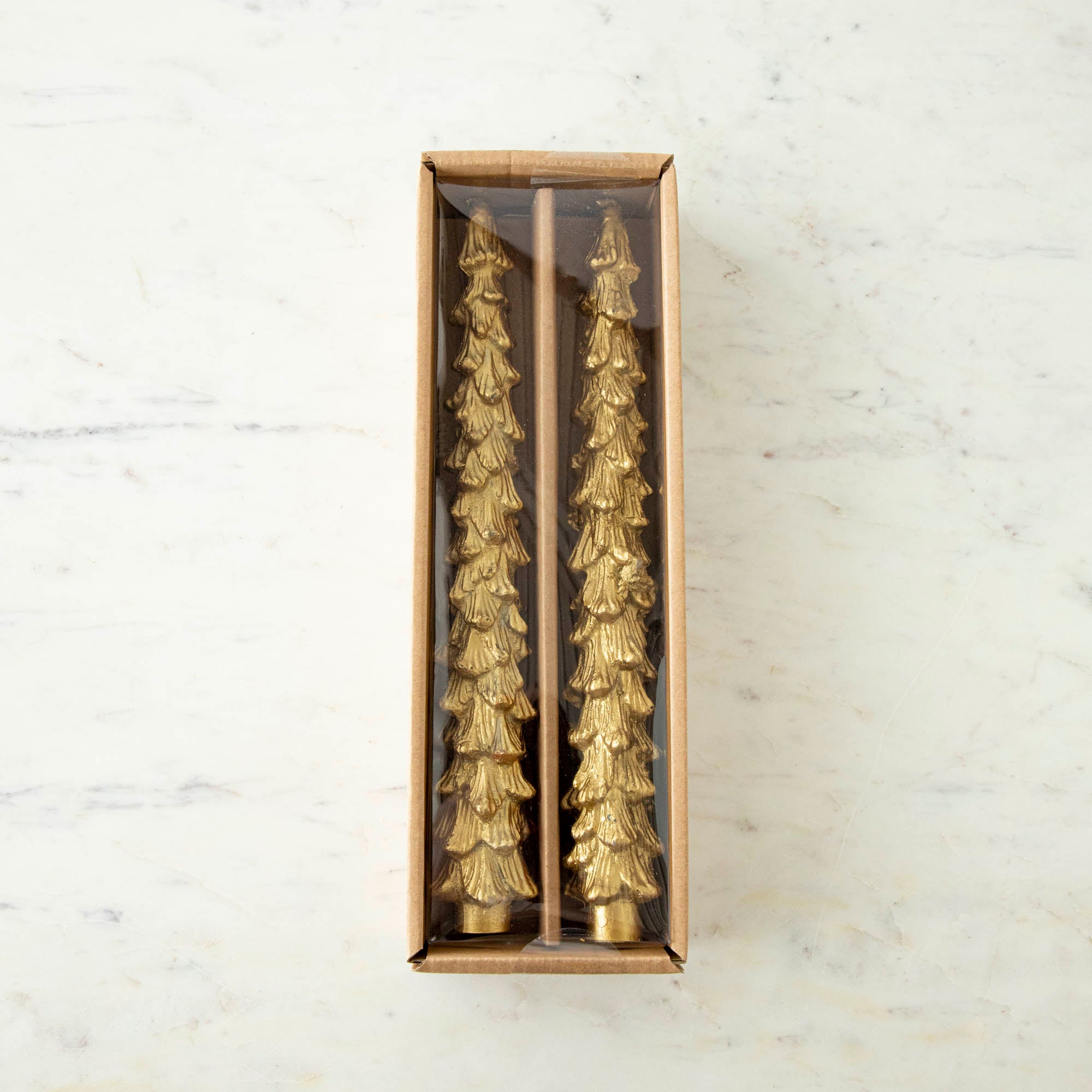Set of 2 tall gold tree shaped taper candles in a box.