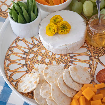 Close-up of a Rattan Weave Serving Paper under cheese and crackers under an elegant charcuterie spread.