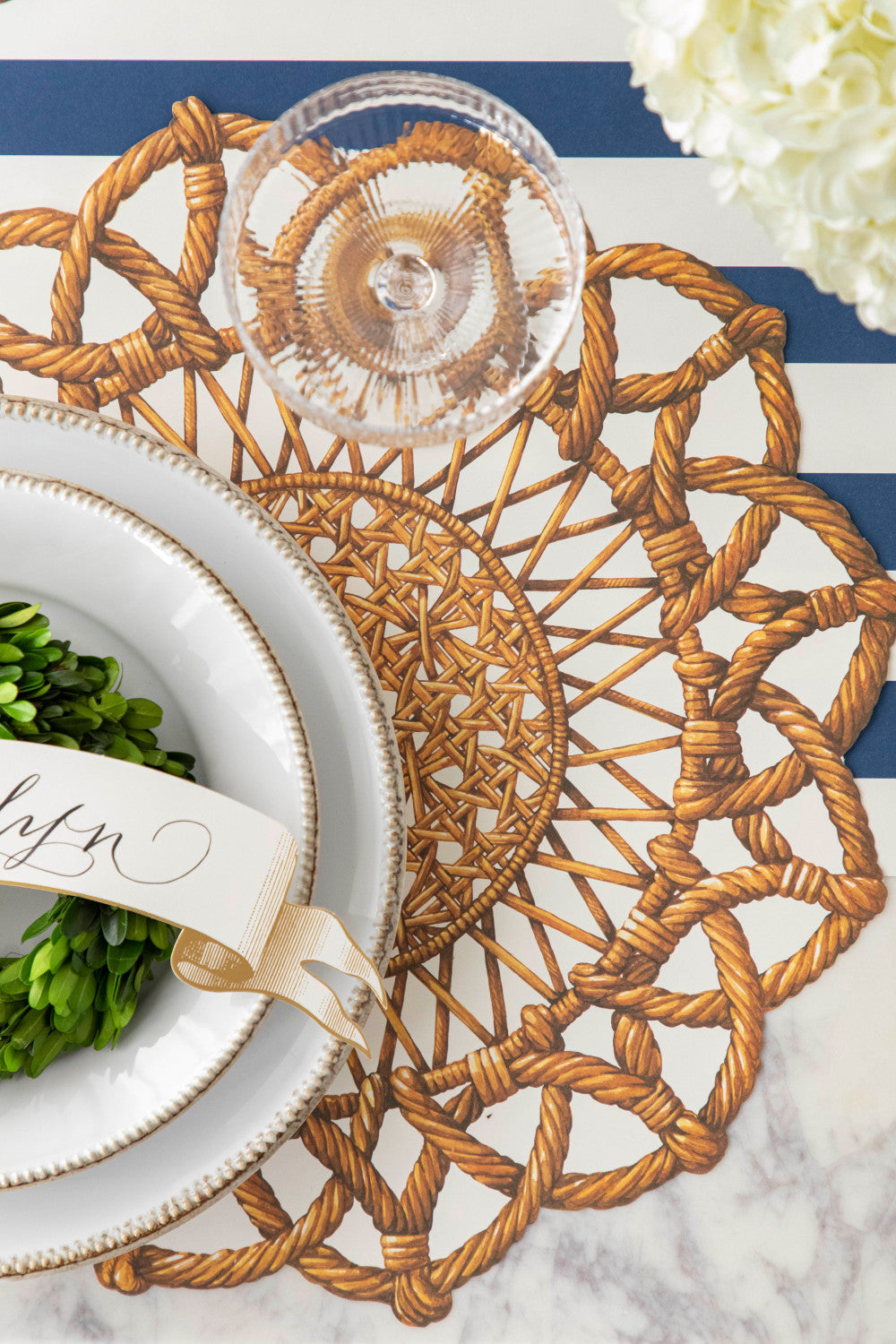 Close-up of the Die-cut Rattan Weave Placemat under an elegant place setting, from above.
