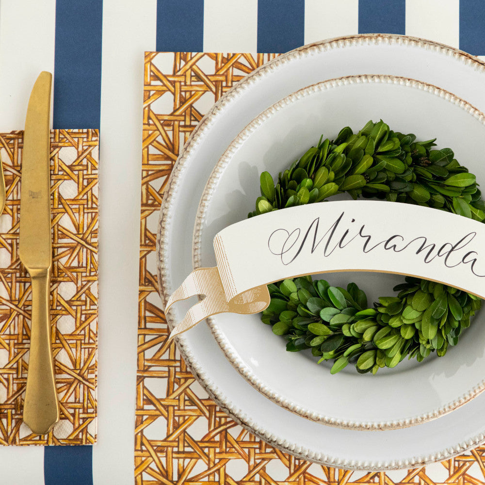 The Rattan Weave Placemat under an elegant place setting, from above.