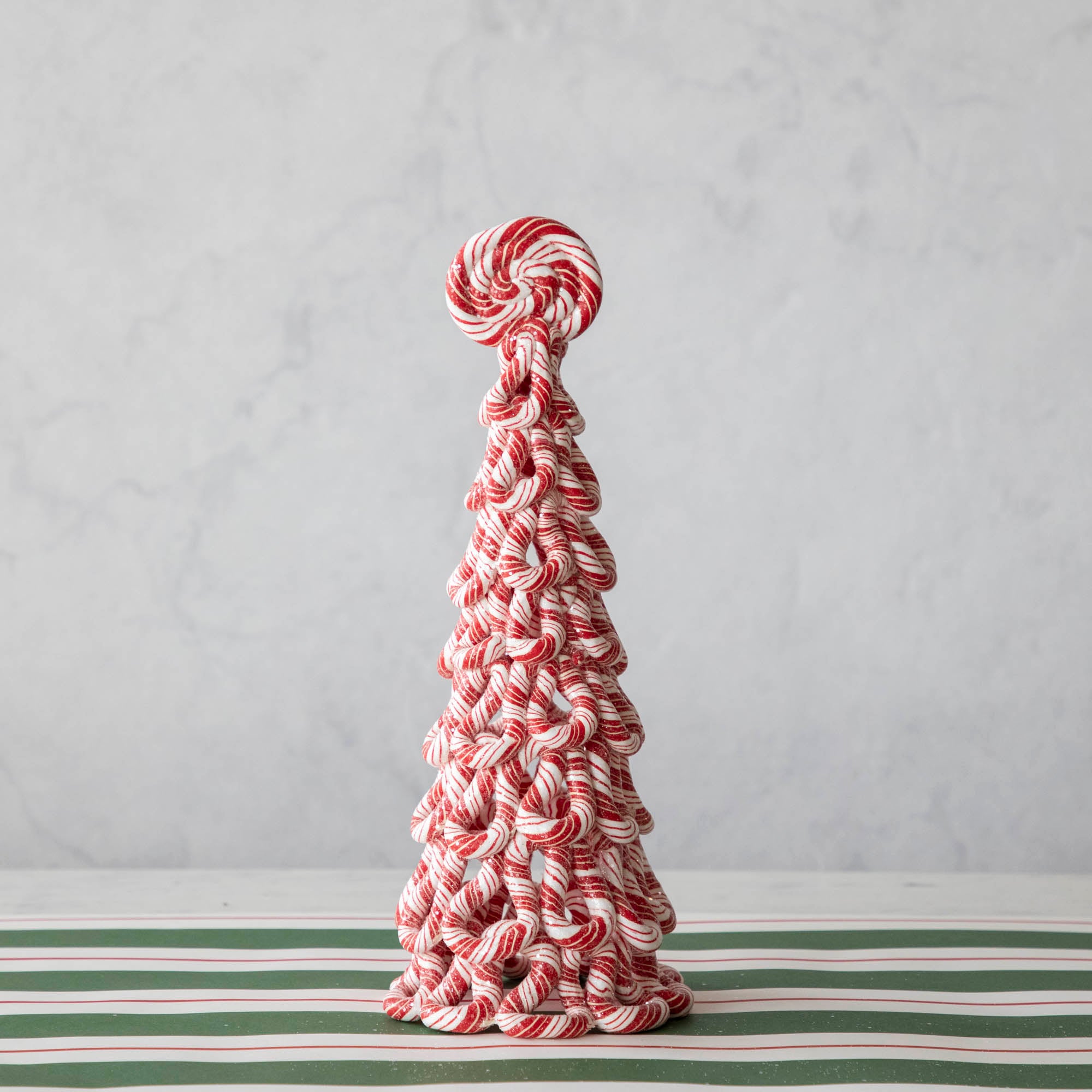 The medium peppermint tree on the Green & Red Awning Stripe Runner.