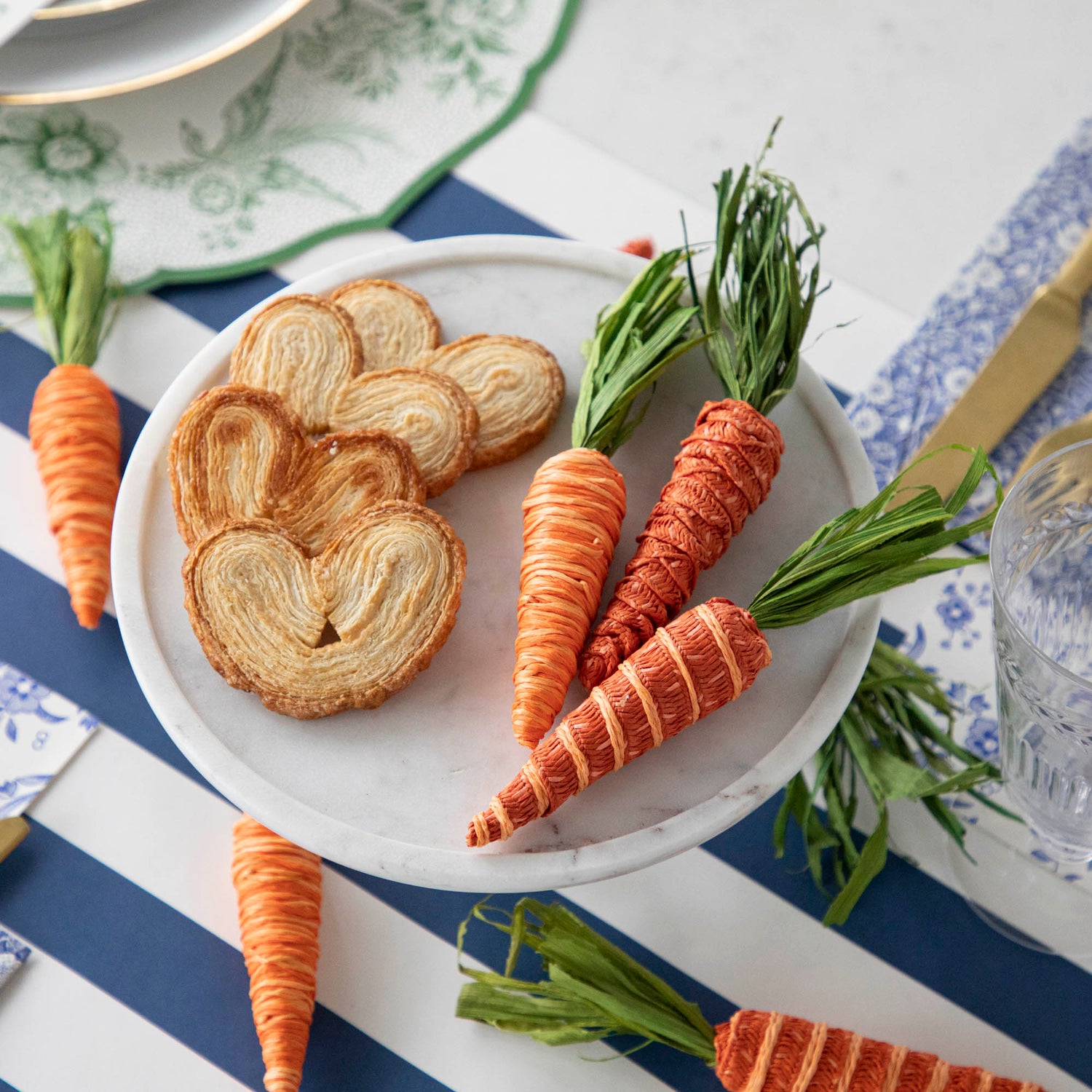 An Easter table setting with Glitterville Natural Carrots and biscuits on it.
