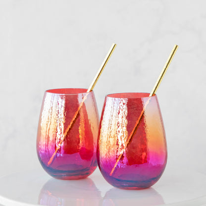 Two Luster Stemless Glassware glasses with golden straws, perfect for enjoying a refreshing drink at home. (Brand: Zodax)