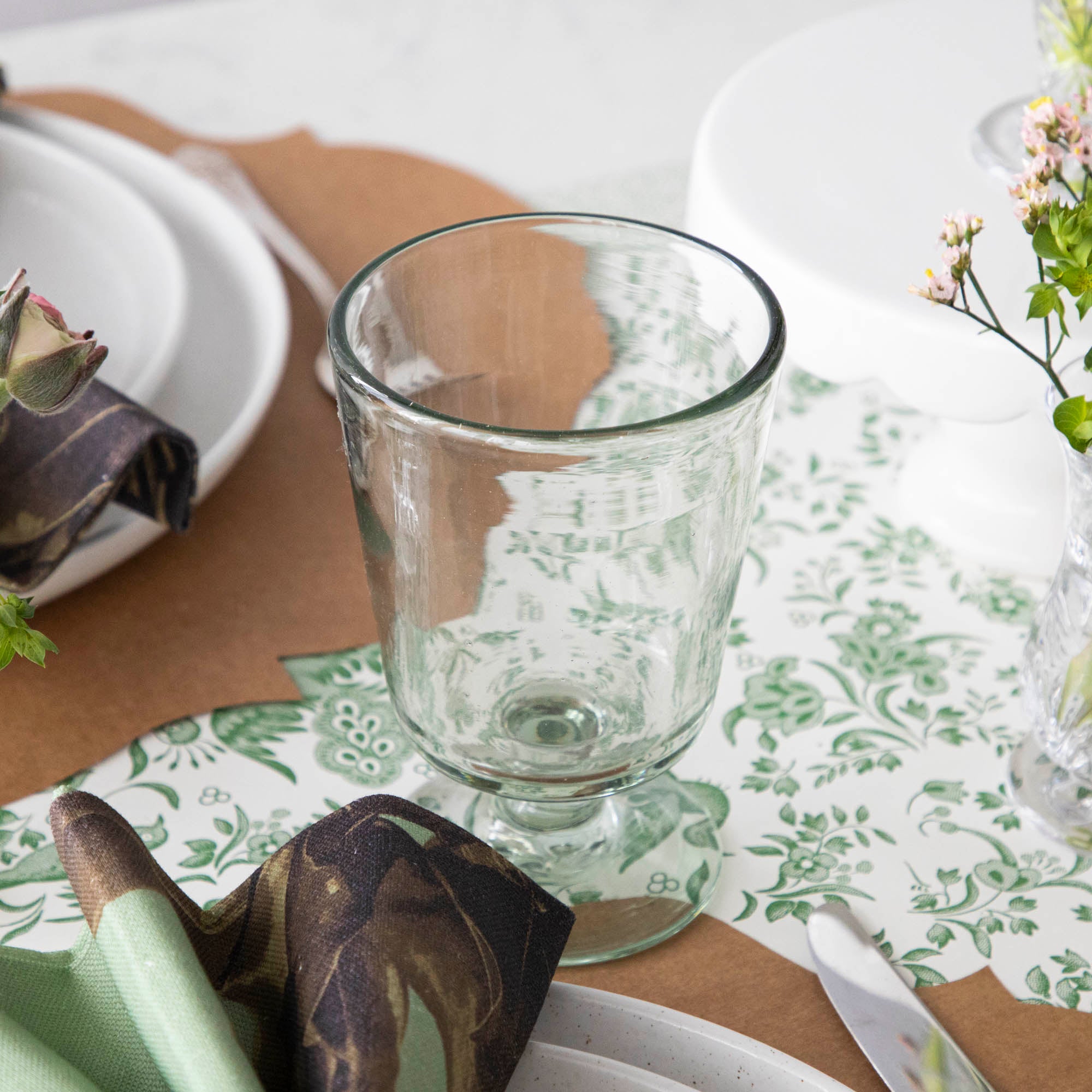 Three empty Margarida Recycled Glasses vessels of varying heights and shapes, made by Casafina Living, rest on a white surface.