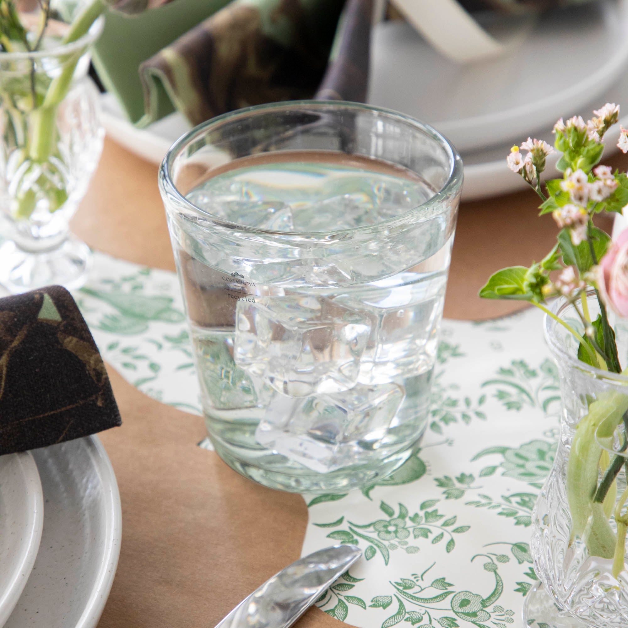 Three empty Margarida Recycled Glasses vessels of varying heights and shapes, made by Casafina Living, rest on a white surface.
