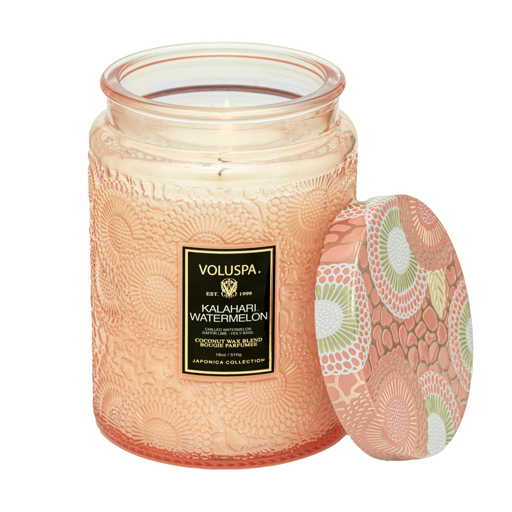 Two Voluspa Kalahari Watermelon candles on a marble surface with matches nearby, featuring a crisp cucumber aroma.