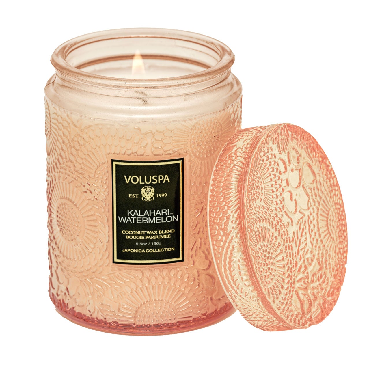 Two Voluspa Kalahari Watermelon candles on a marble surface with matches nearby, featuring a crisp cucumber aroma.