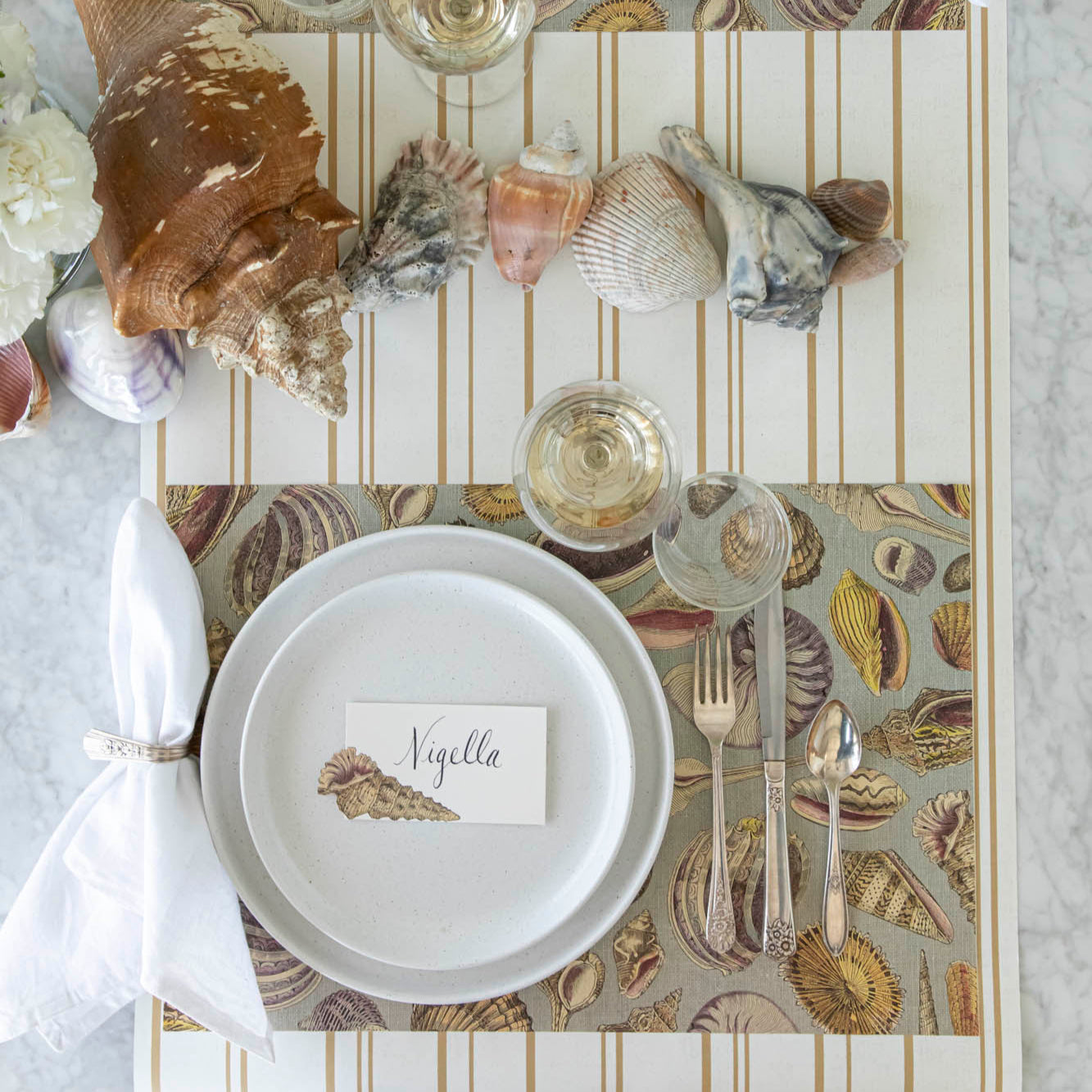 Shell Study Placemat under an elegant place setting on the Antique Gold Stripe Runner.