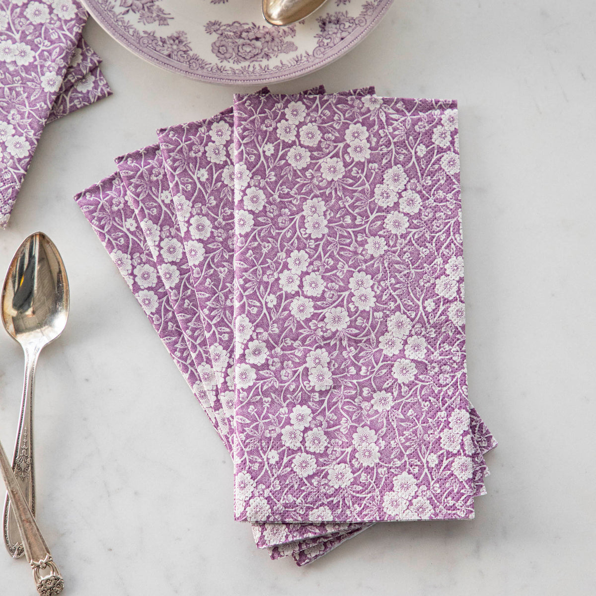 Exquisitely decorated Lilac Calico Napkins by Hester & Cook on a marble table.