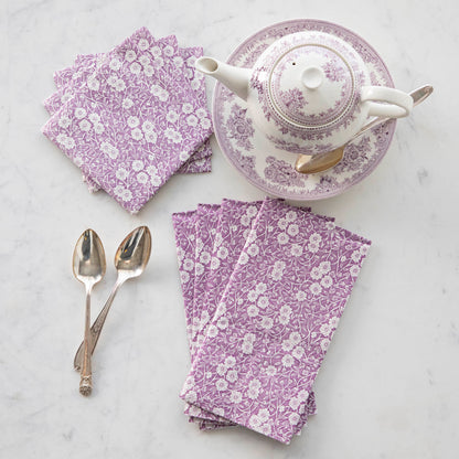 A set of beautiful Lilac Calico napkins with a lilac-accented teapot and silver spoons on a marble table by Hester &amp; Cook.