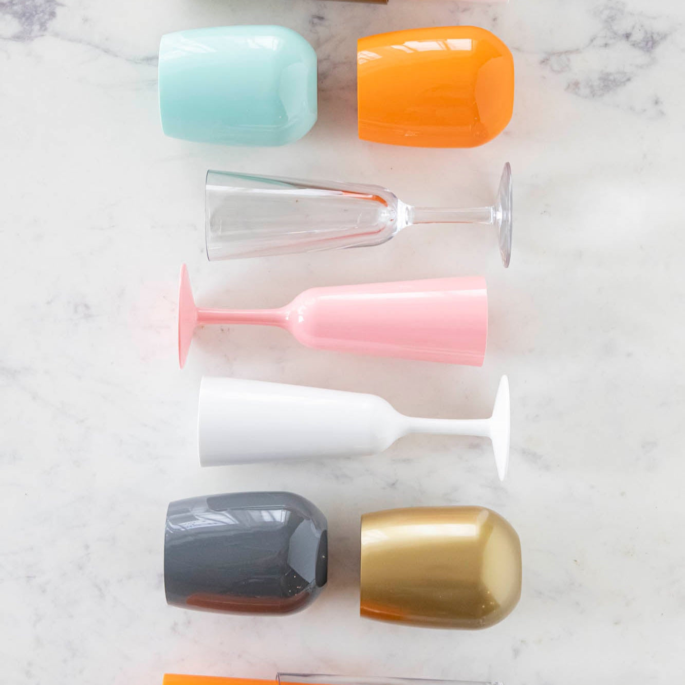 An assorted mix of symGlass lined up on a marble table.