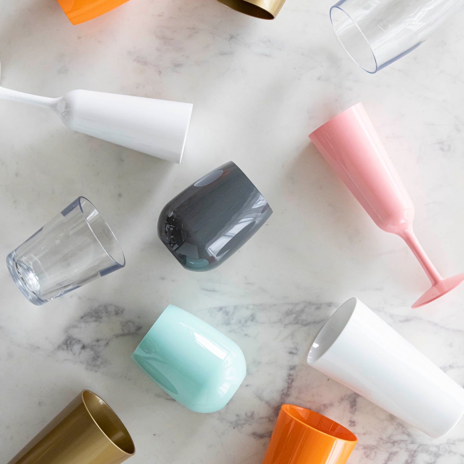 An assorted mix of symGlass lined up on a marble table.