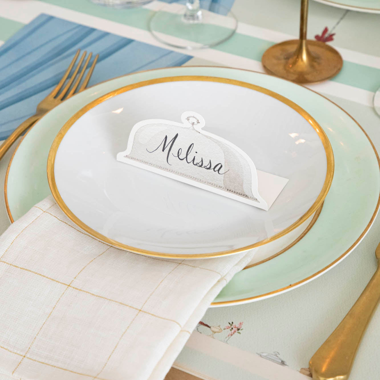 Serving Dome Place Card with "Melissa" written on it, on dinner plates.