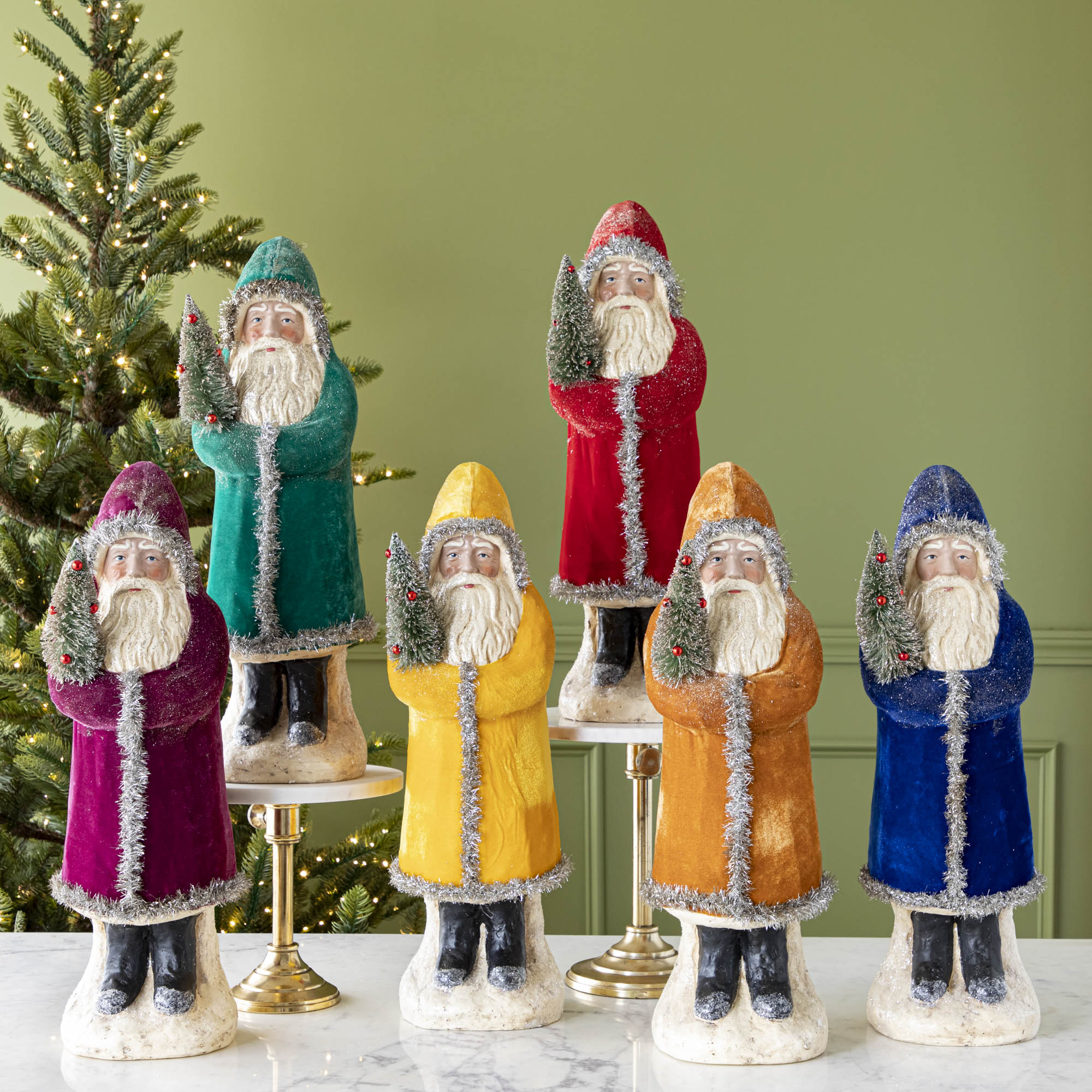 Six assorted 22" Velvet Belsnickle figurines with a velvet robe adorned with tinsel trimming and glitter, holding a tree.