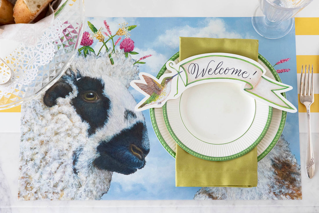 A spring-themed set of Hester & Cook's "I Love Ewe" placemats featuring a sheep on the table.