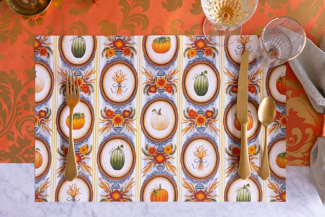 Decorative placemat with autumn-themed design on a table setting.