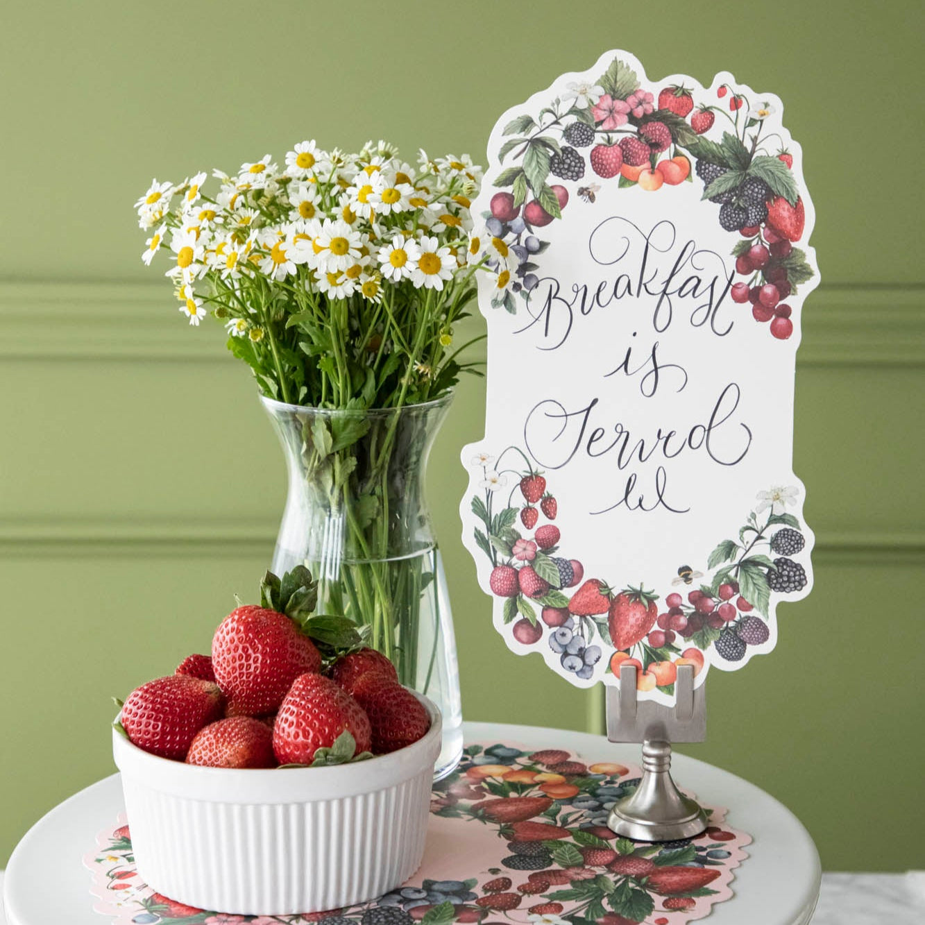 Berry Bramble Table Accent with "Breakfast is Served" written in script, held by the Chrome Place Card Holder.