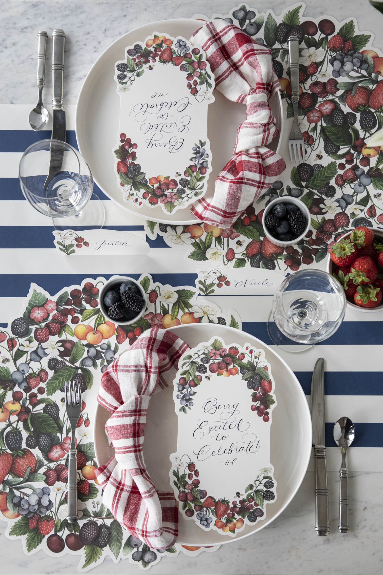 A berry-themed table setting for two featuring a Berry Bramble Table Card resting on each plate.