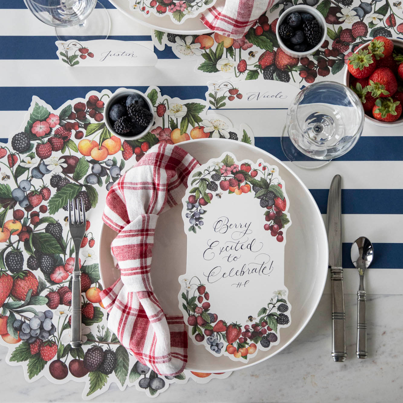 A berry-themed table setting for two featuring a Berry Bramble Table Card resting on each plate.