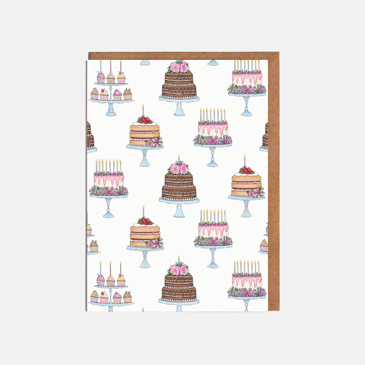 Pattern of cakes printed on a greeting card on a white background.