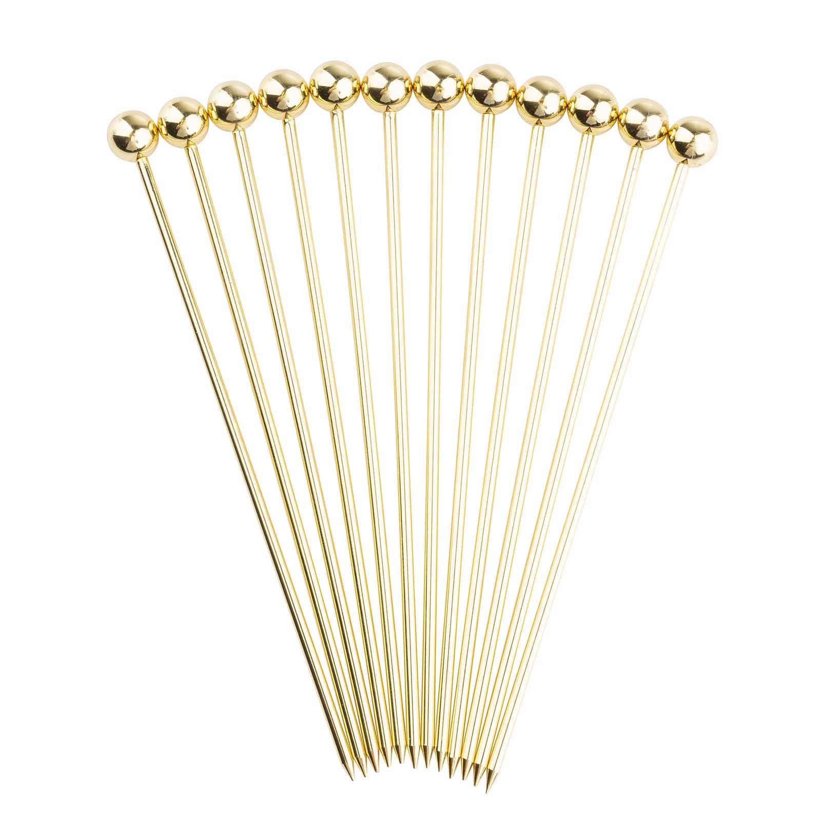 Set of 12 gold cocktail picks on a white background.
