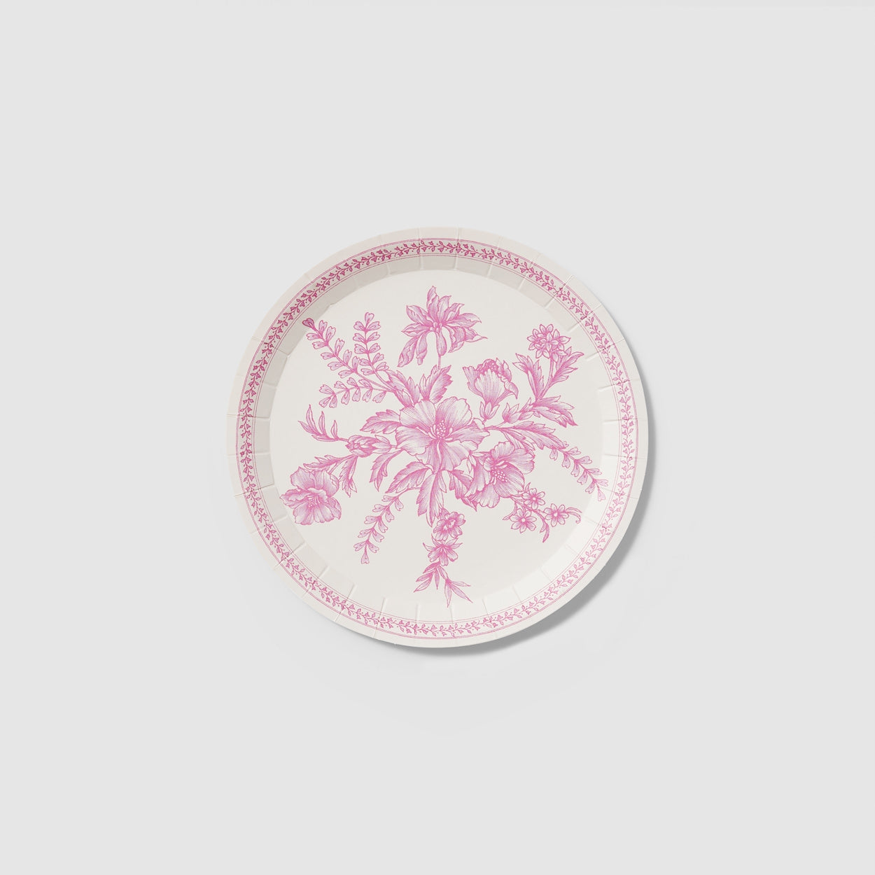 A table set with Pink French Toile Paper Party Dinnerware plates from Coterie Party Supplies featuring floral toile dinnerware patterns that evoke the charm of the French countryside, complemented by silverware.