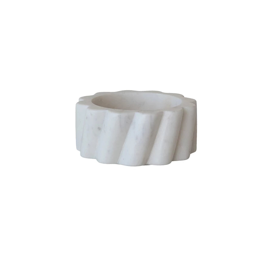 White marble bottle holder with wavy design on a white background.