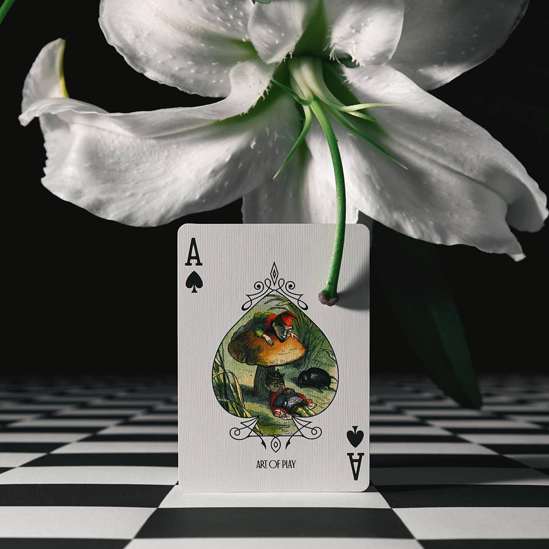 Ace of Spades card with a white flower on a black and white checkered background