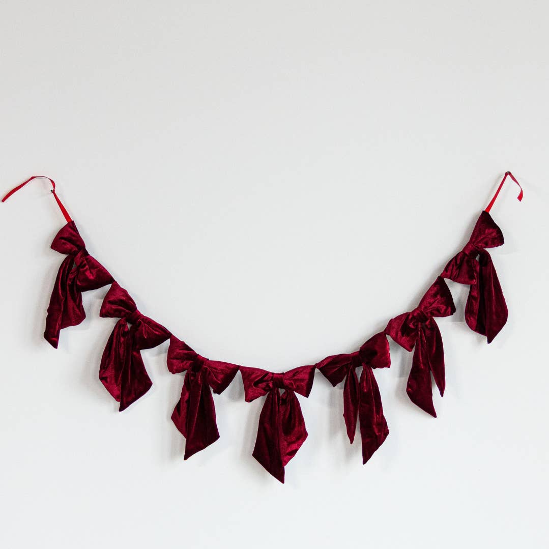 Red velvet bow banner on a white background.
