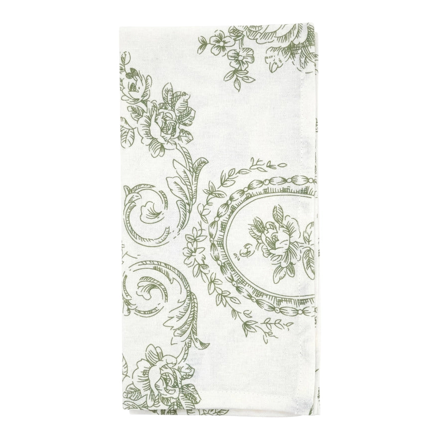 White fabric with green floral and decorative pattern on a white background