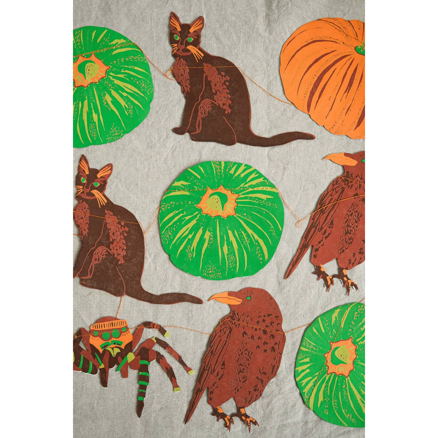 In bold greens and bright oranges, this garland features all the traditional images of Halloween - cats, ravens, spiders and pumpkins.