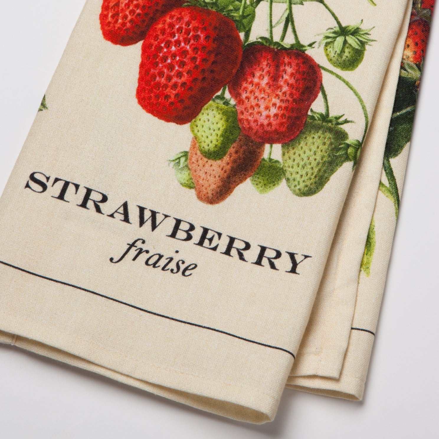 Tea towel with strawberry design and text on a white background.