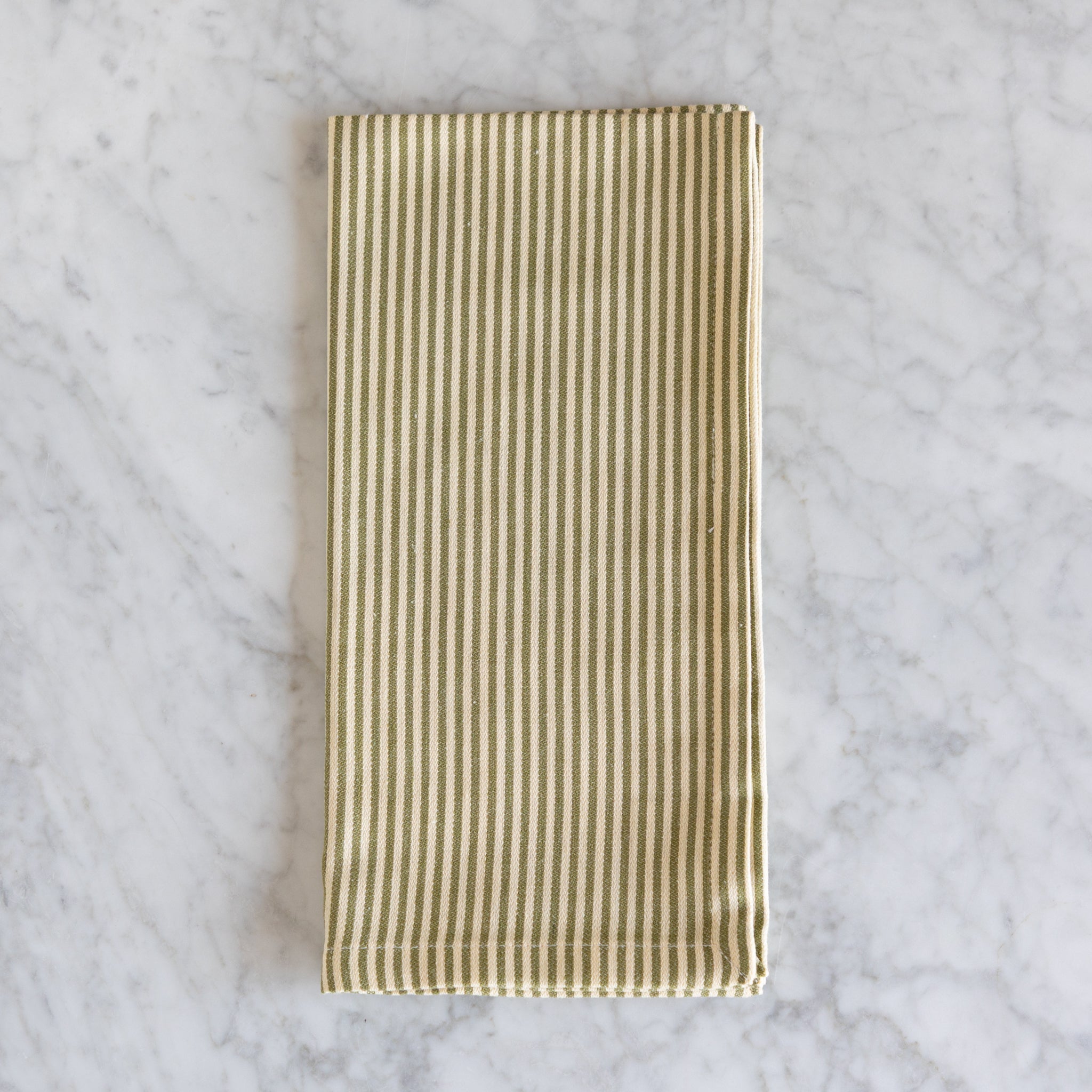 Striped fabric napkin on a marble surface.