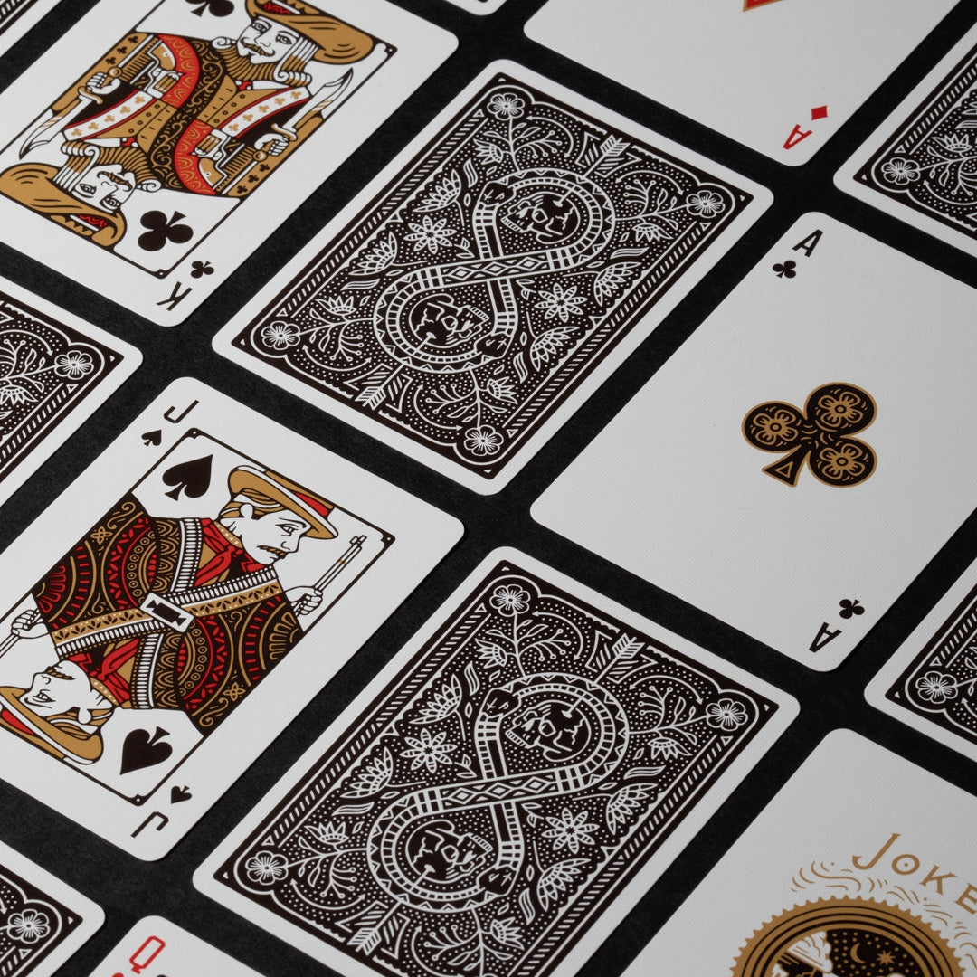 Close-up of playing cards with intricate designs on a black and white background