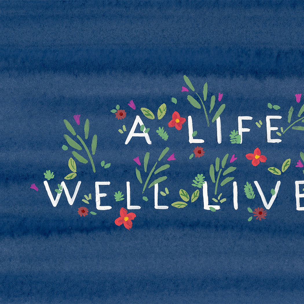 A blue greeting card with flowers surrounding text that reads &quot;A life well lived&quot;