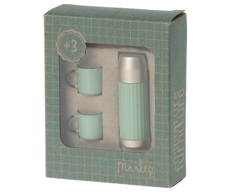 A Mini Thermos and Cups Set from Maileg, with two cups and a teapot in a green box. The cups are perfectly sized for sipping your favorite blend, and the teapot allows for easy pouring. This set