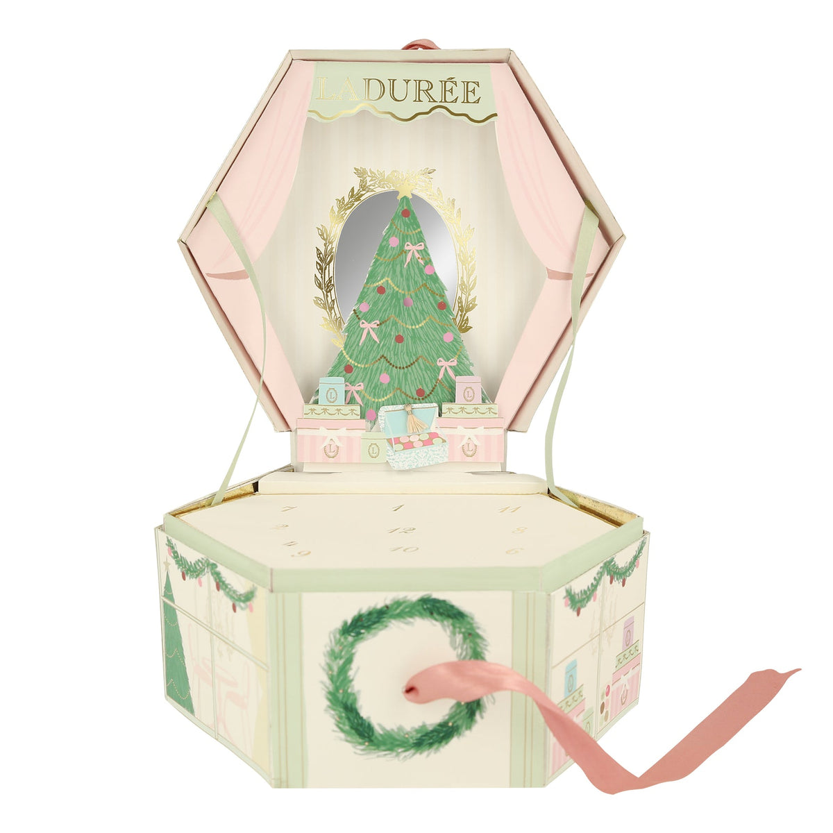 A Ladurée x Meri Meri branded charm bracelet advent calendar in a box with a Christmas tree and festive decorations, containing numbered trays with charms and tassels.