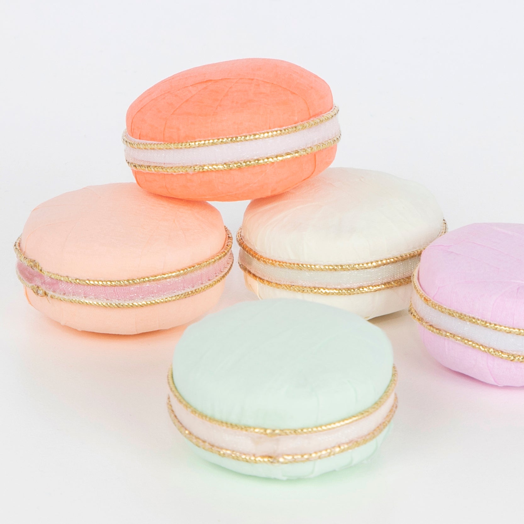 A group of Ladurée Paris Macaron Surprise Balls, arranged beautifully on a white surface.