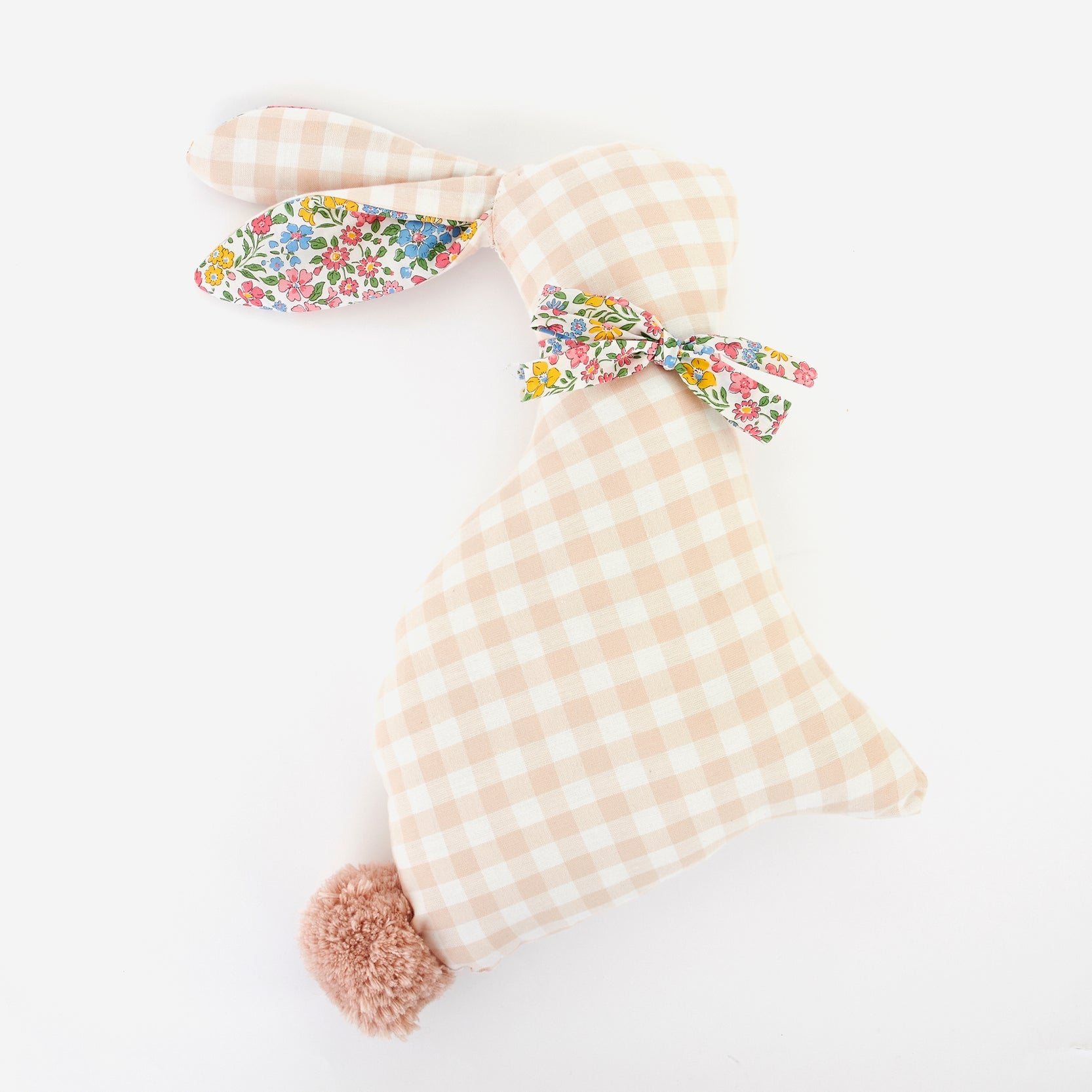 A beige and pink gingham fabric bunny cushion with floral details and a pom-pom tail.