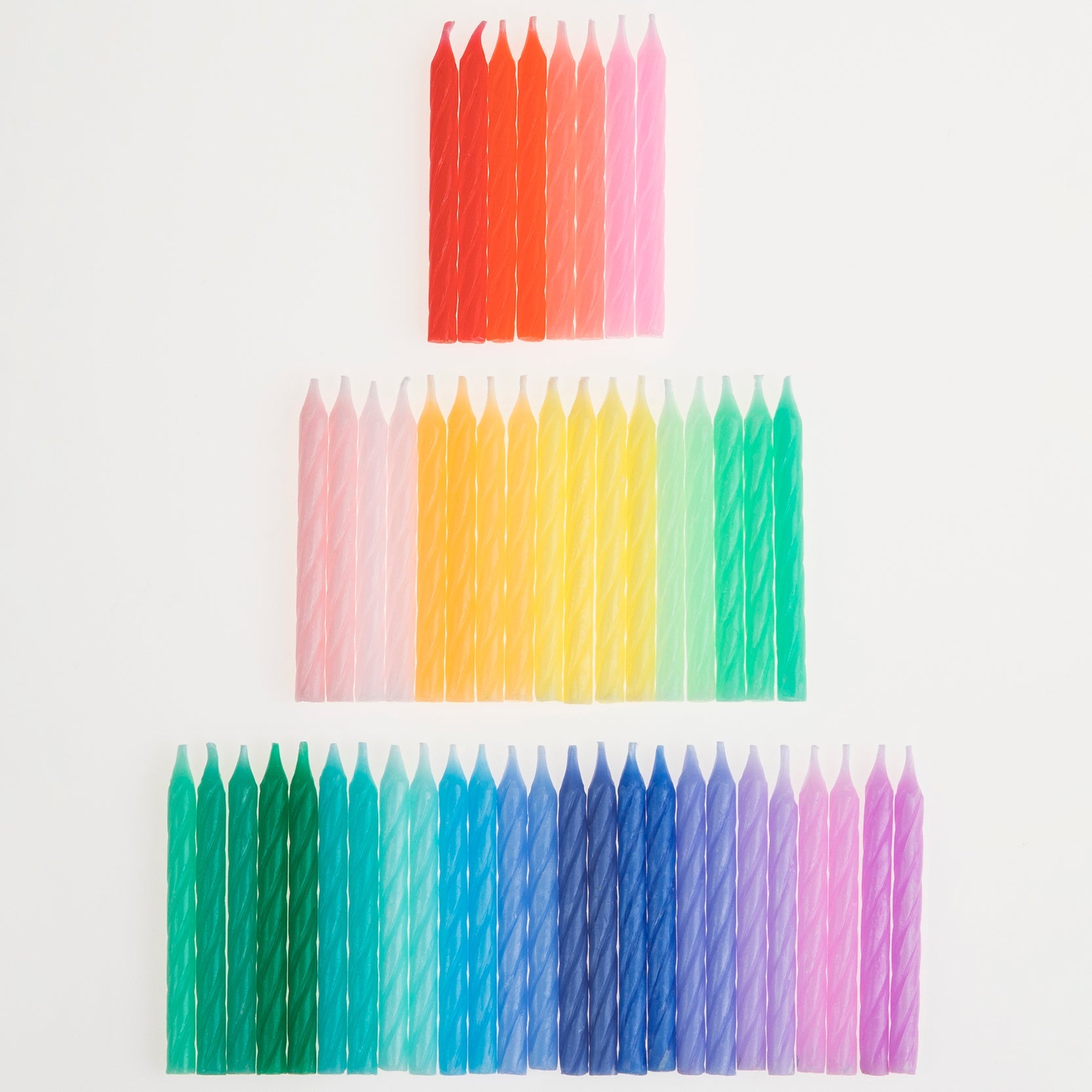 A set of Rainbow Twisted Mini Candles by Meri Meri in a box, perfect for a celebratory party theme.