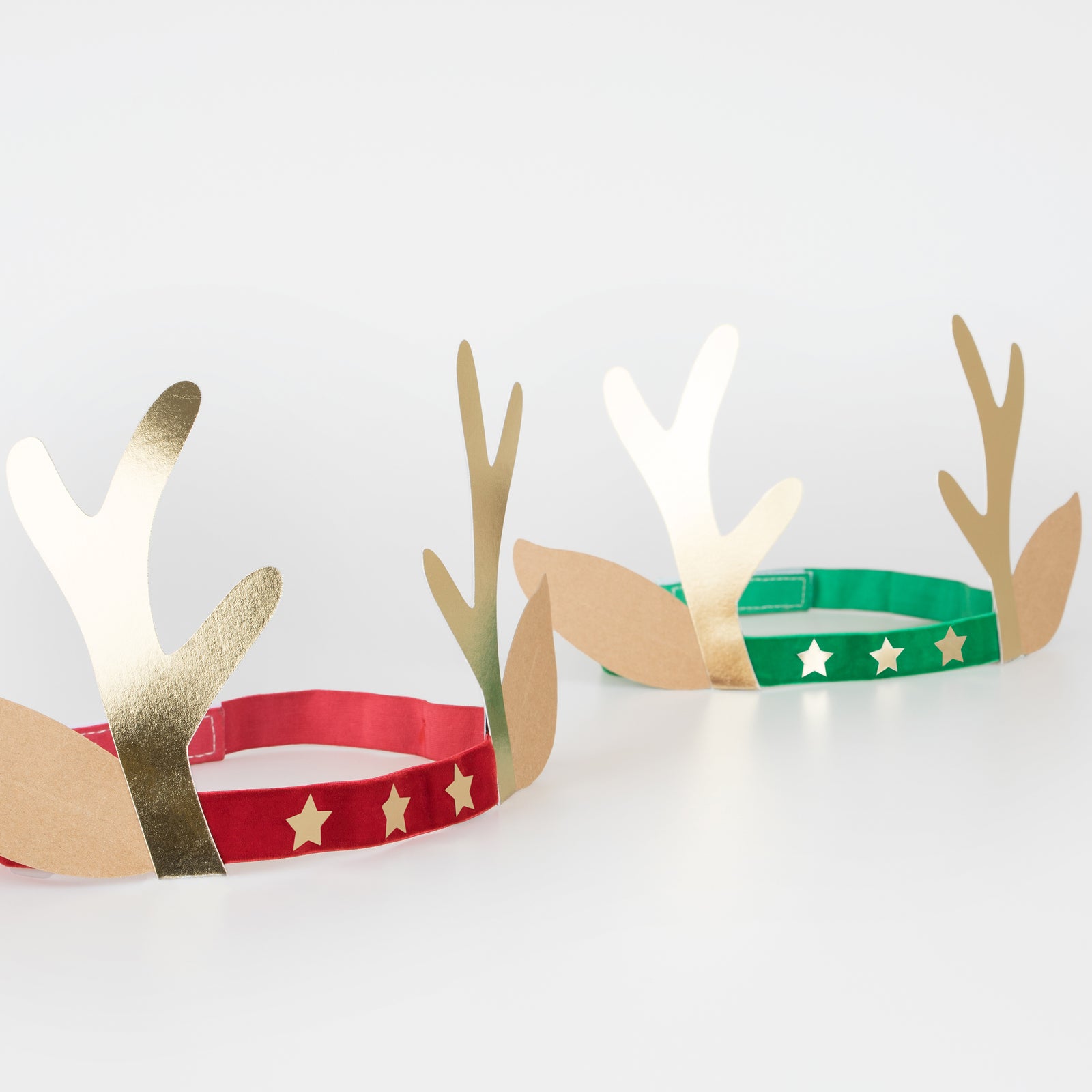 Two reindeer antler headbands in red and green.