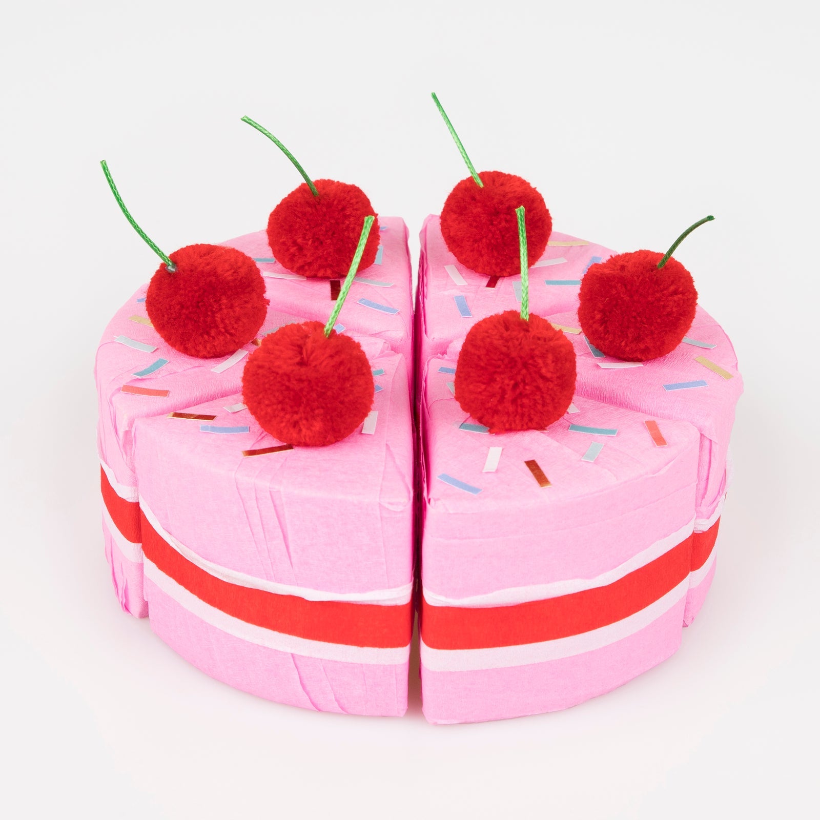 Meri Meri Surprise Cake Slices. A box of 6 cakes slices crafted with red, white and pink crepe paper. Each slice is topped with a red pompom cherry with a green cord stalk, and sprinkle stickers.