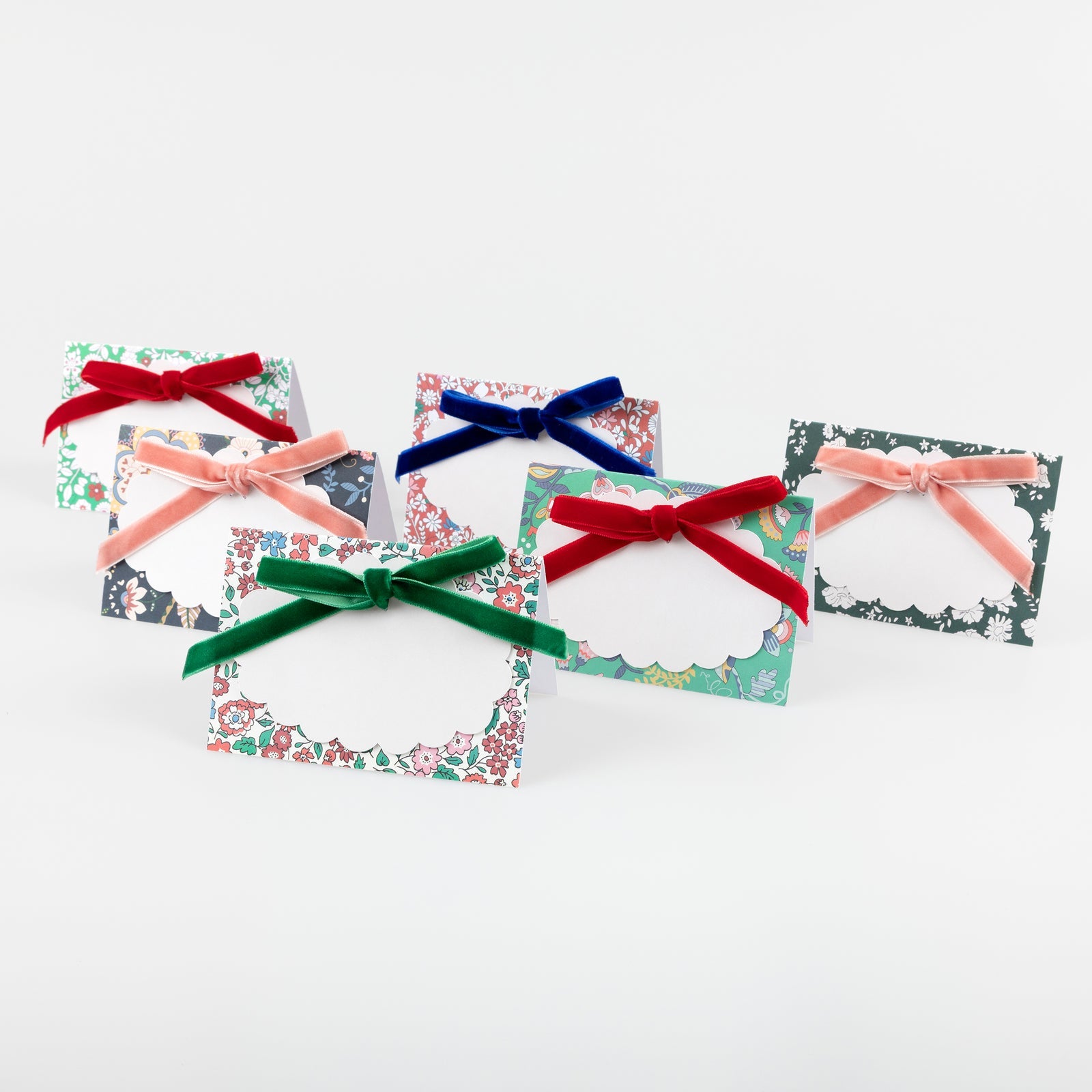 Five decorative cards with colorful bows on a white background