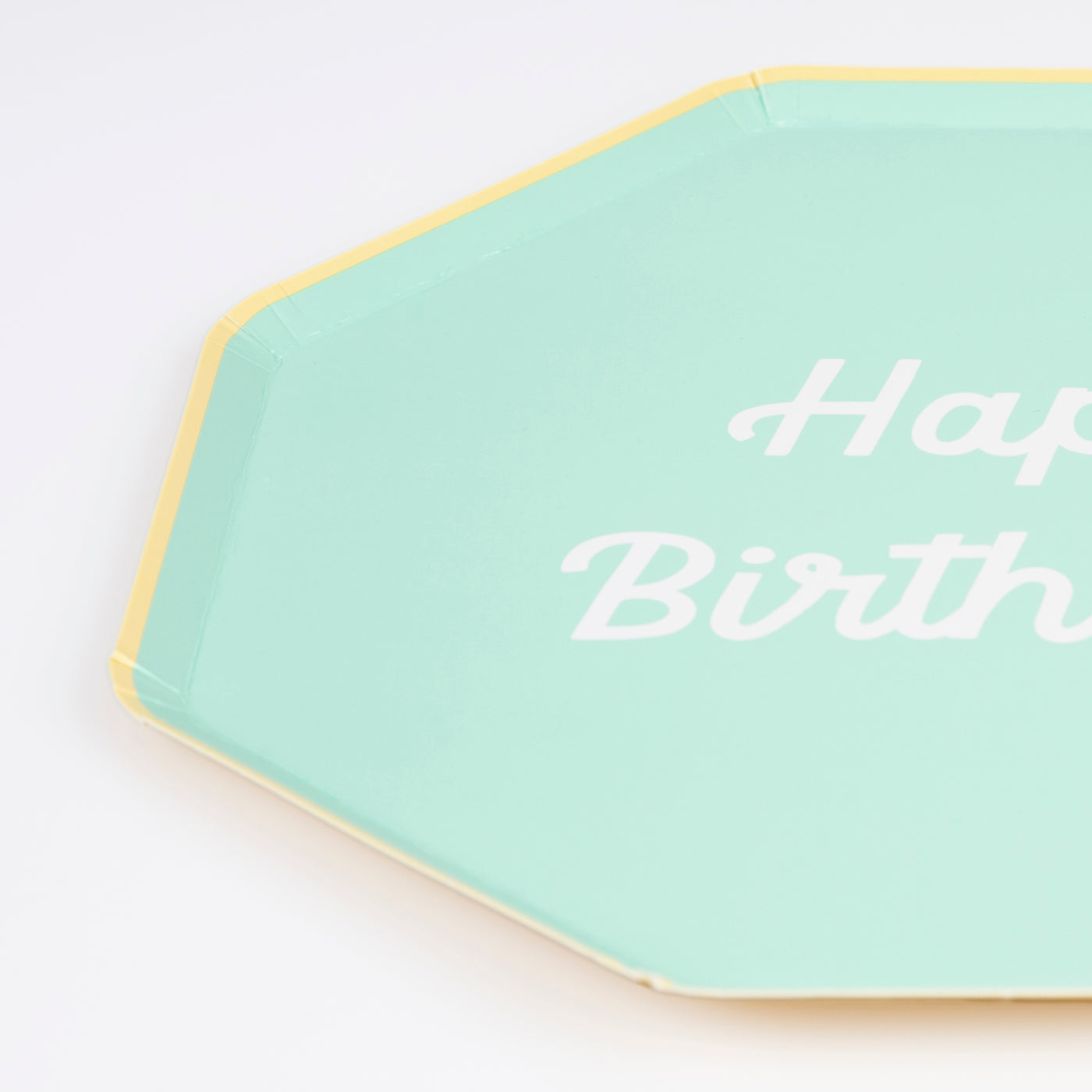 Octagonal shaped paper plate in mint saying "Happy Birthday!".